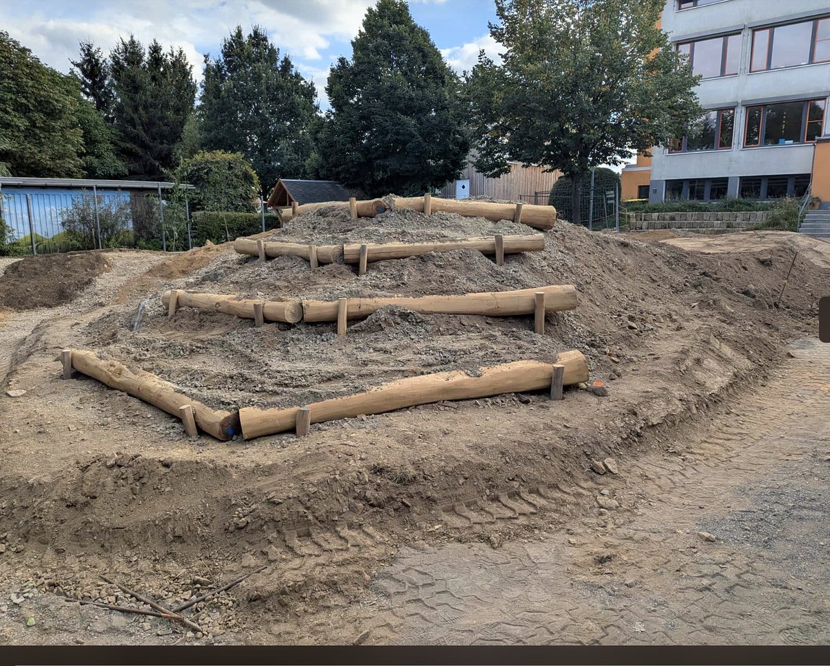 Sitz- und Kletterterrassen aus Holzpalisaden auf dem neuen Hügel
